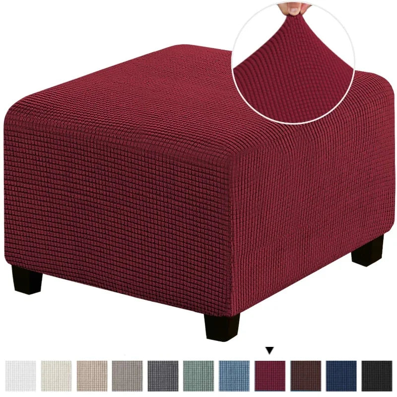 A square jacquard footrest ottoman slipcover in a deep maroon color.