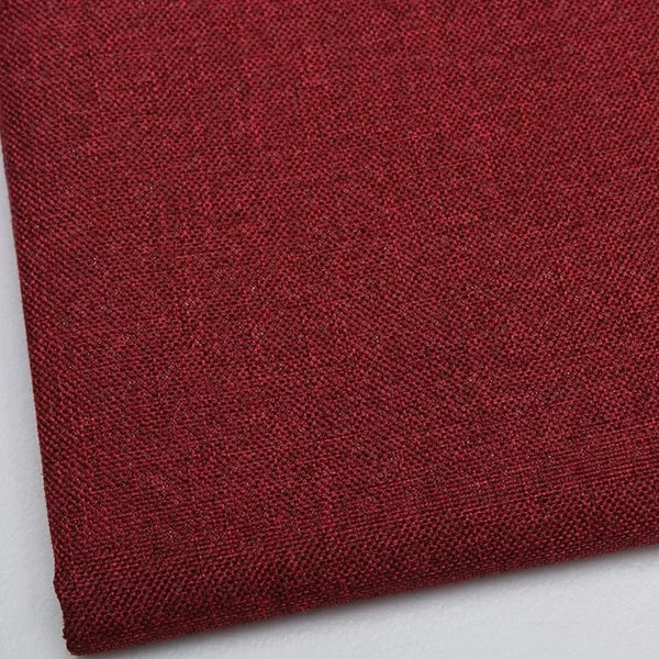 Close-up of a deep maroon coarse linen and cotton fabric textile.