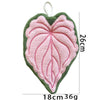 A handmade heart-shaped towel featuring pink and green textured fabric.