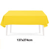 A bright yellow rectangular tablecloth displayed on a white table.