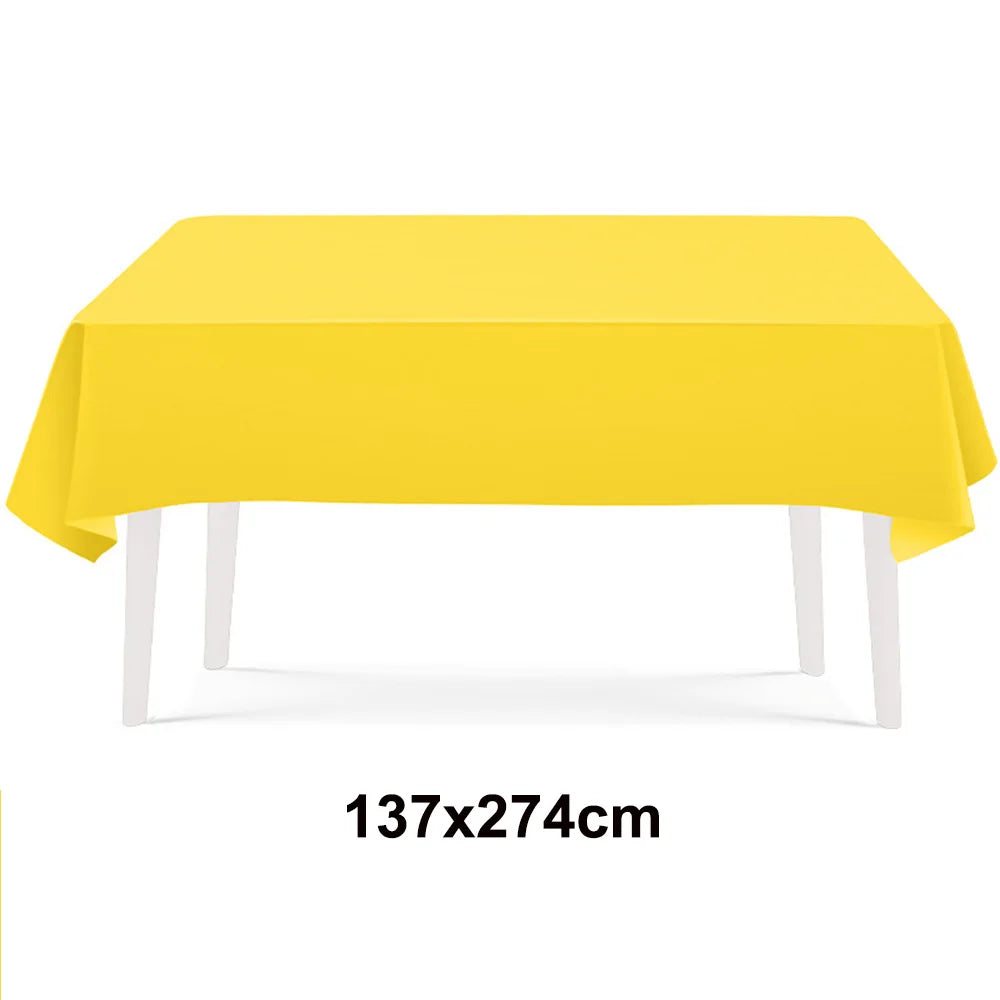 A bright yellow rectangular tablecloth displayed on a white table.