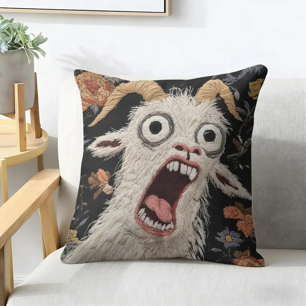 A black cushion cover featuring a distressed, screaming goat face with wide eyes and an open mouth.