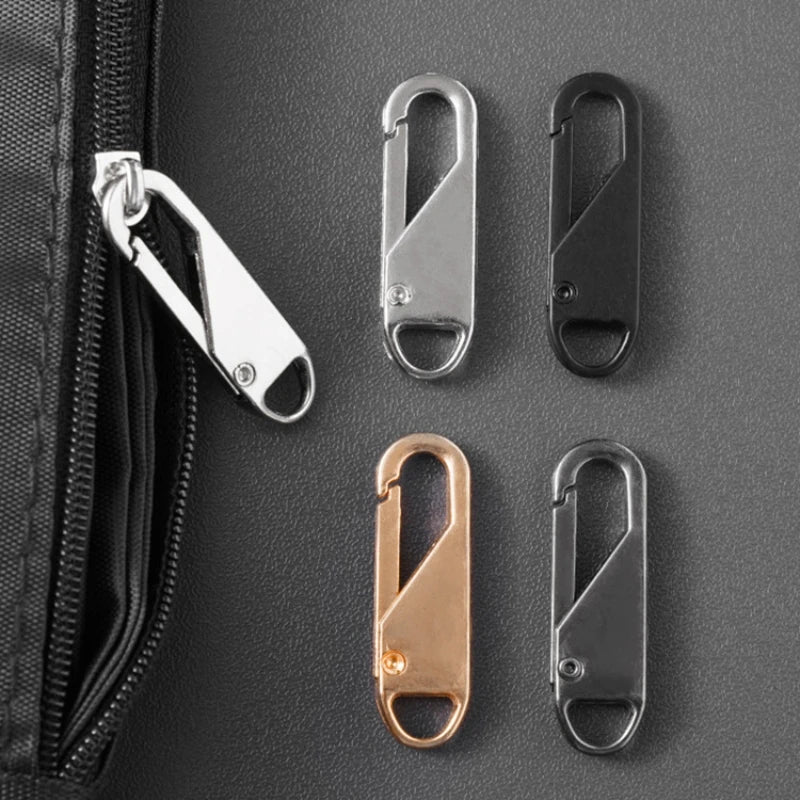 A set of metal zipper pulls in silver, black, and rose gold are displayed against a dark gray fabric background.