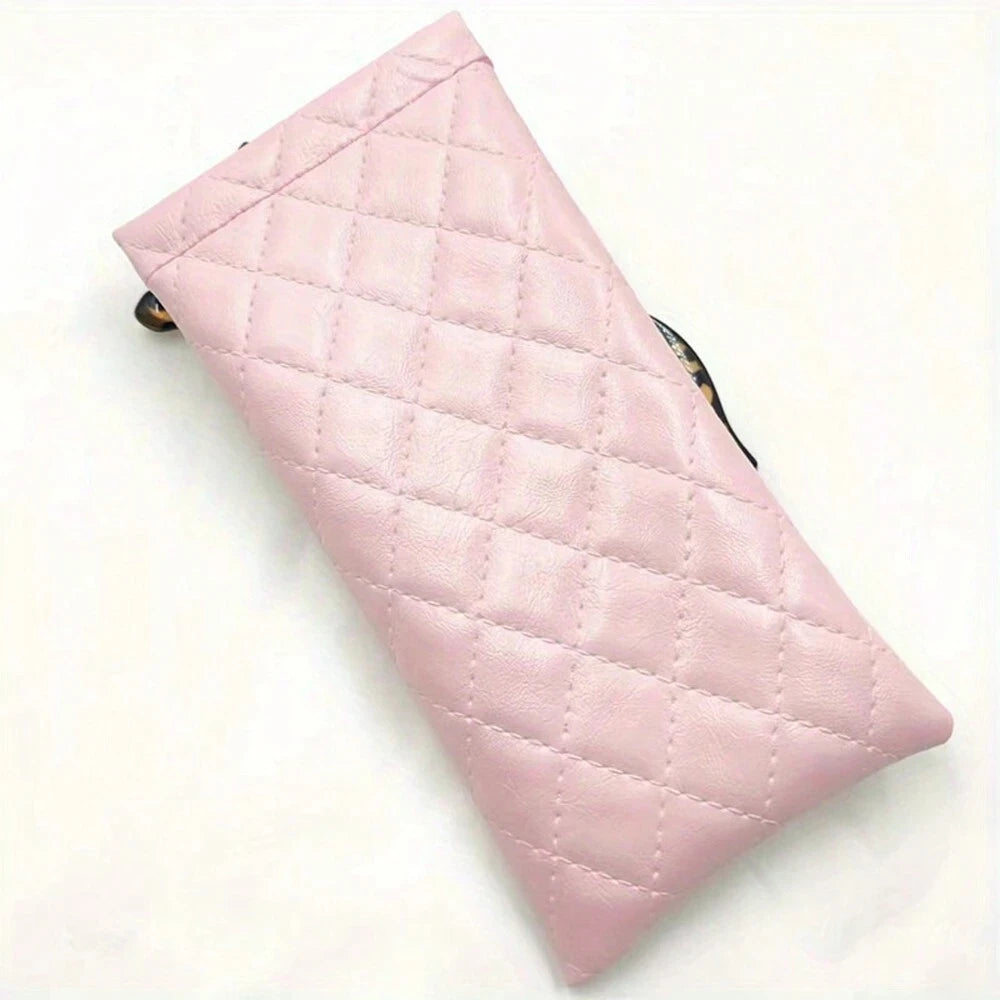 A light pink quilted PU leather eyeglass case with a cleaning cloth.