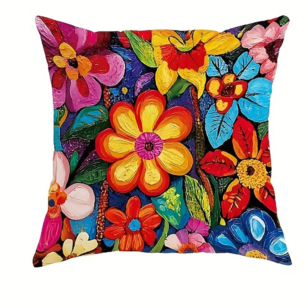 A decorative pillow cover featuring a vibrant, colorful floral pattern with various shades of pink, yellow, orange, and blue.