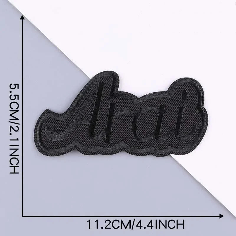Black embroidered leather patch with a wavy design on a white background.