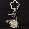 Silver star-shaped pocket watch keychain with a clear face and adjustable chain.