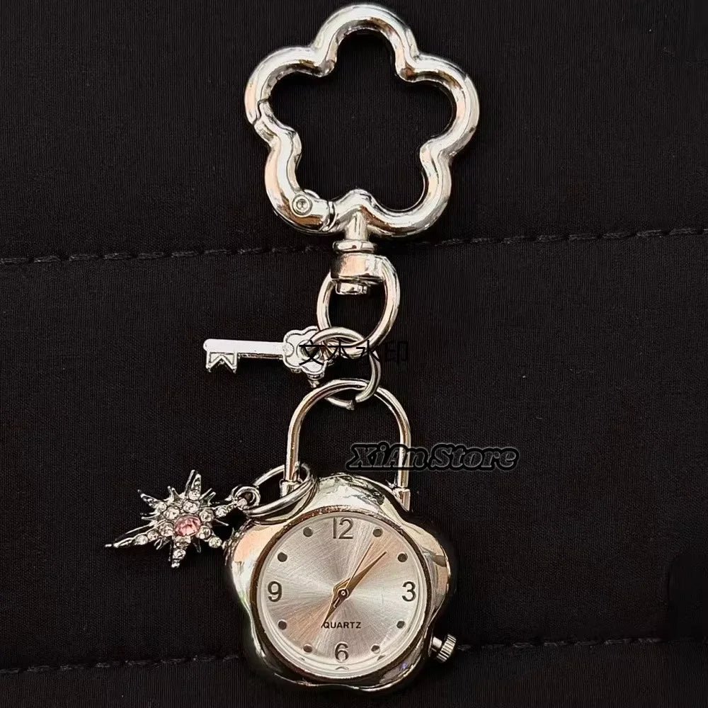 Silver star-shaped pocket watch keychain with a clear face and adjustable chain.
