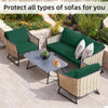 Green outdoor sofa cushion covers protecting wicker sofas in a garden setting.