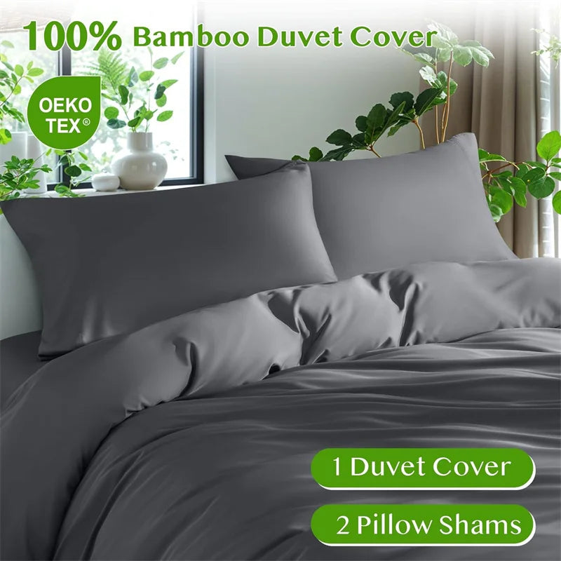A gray bamboo duvet cover set displayed on a bed with green plants in the background.