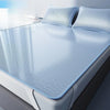 A set of three light blue cooling ice silk sheets laid out on a bed.