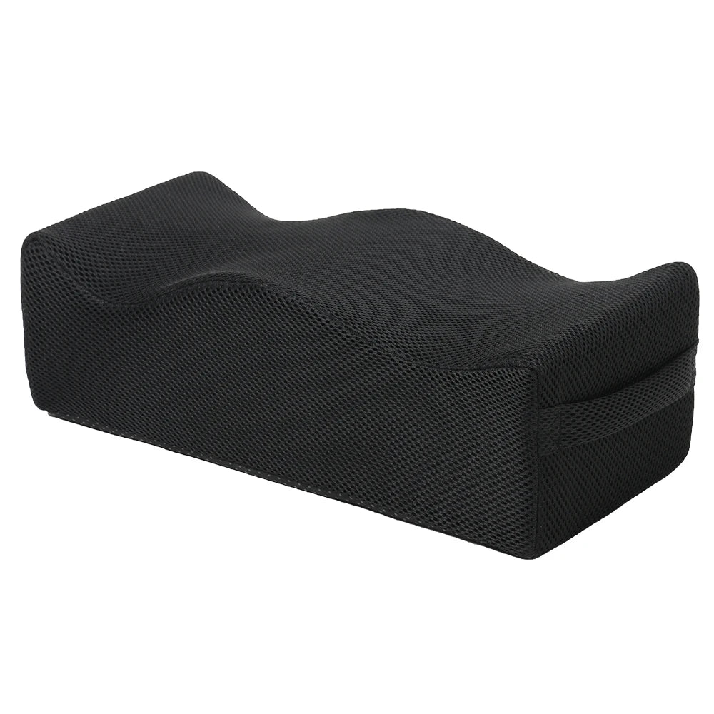 Black ergonomic seat cushion designed for tailbone relief and hip support