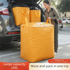 A large yellow waterproof storage sack is shown being loaded into the trunk of a car.