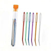 A set of bent tip tapestry needles in various colors including orange, green, purple, and gold.