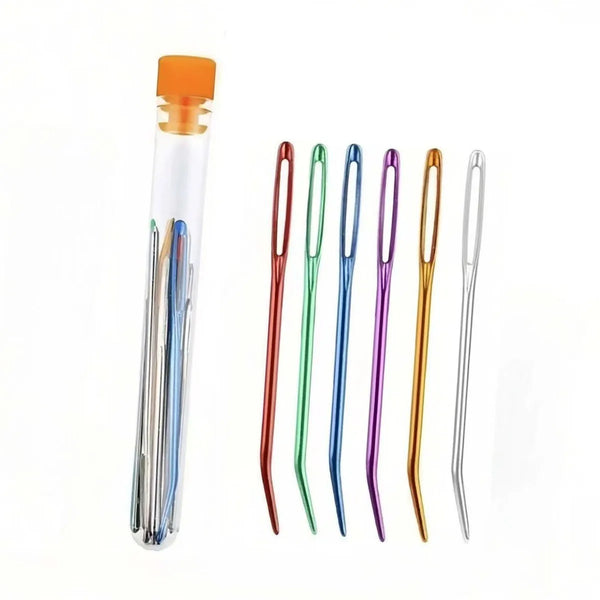A set of bent tip tapestry needles in various colors including orange, green, purple, and gold.