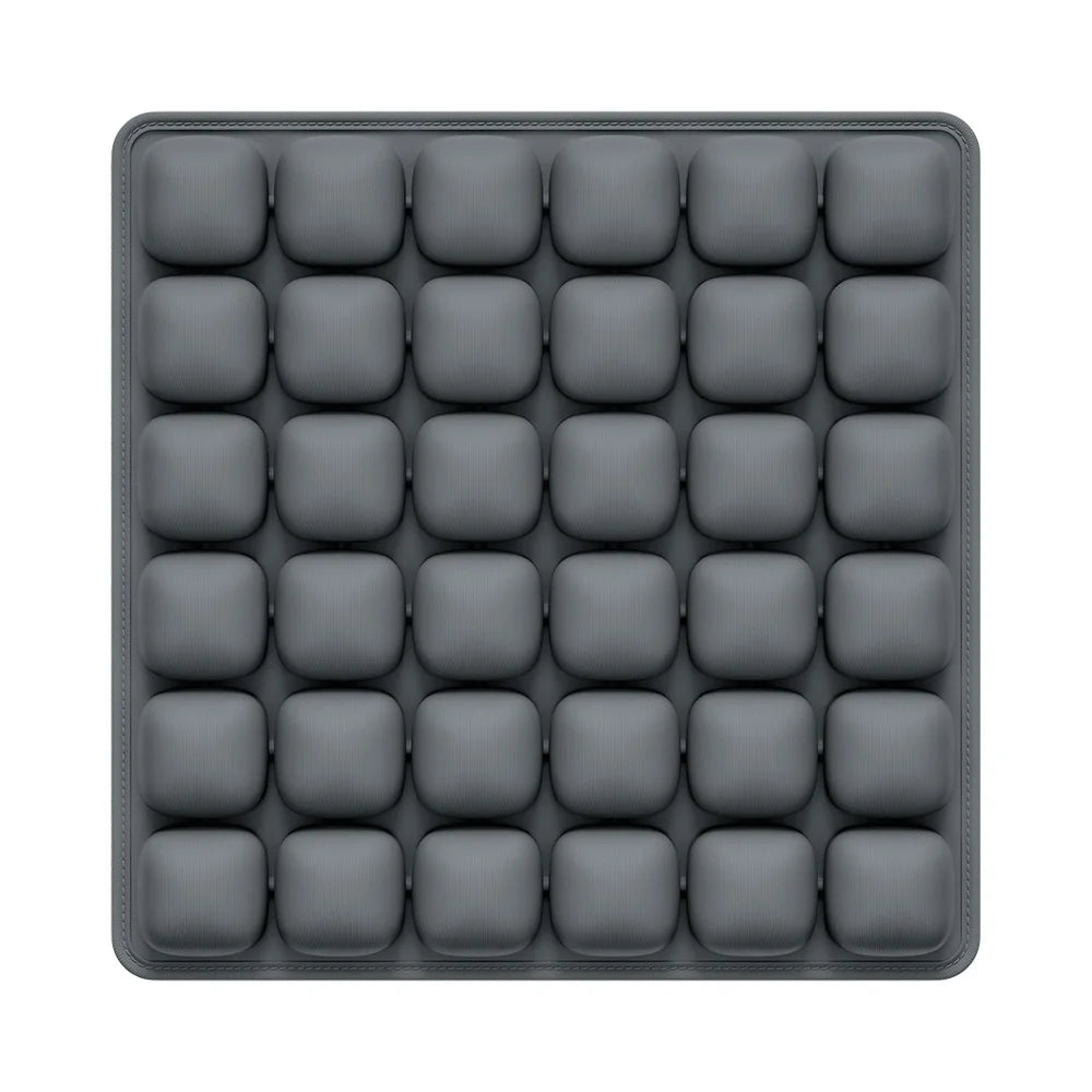 A gray seat cushion with multiple individual air cells for adjustable pressure relief.