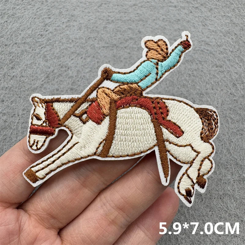 Embroidered iron-on patch of a Western cowboy riding a white horse.