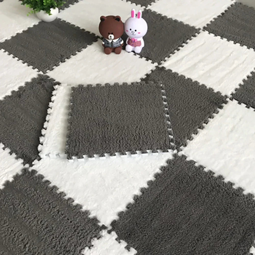 A gray and white checkered play mat featuring soft plush bear and rabbit toys.