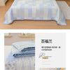 Light blue floral quilted bedspread featuring a patchwork design and soft texture.