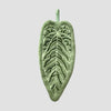 A green, textured leaf shaped hand towel.