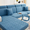 A teal jacquard plush sofa cushion cover featuring a geometric woven pattern on a sectional sofa.