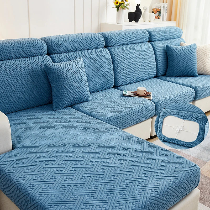 A teal jacquard plush sofa cushion cover featuring a geometric woven pattern on a sectional sofa.