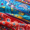 Close-up of colorful bohemian printed linen fabric showing various floral patterns and vibrant colors