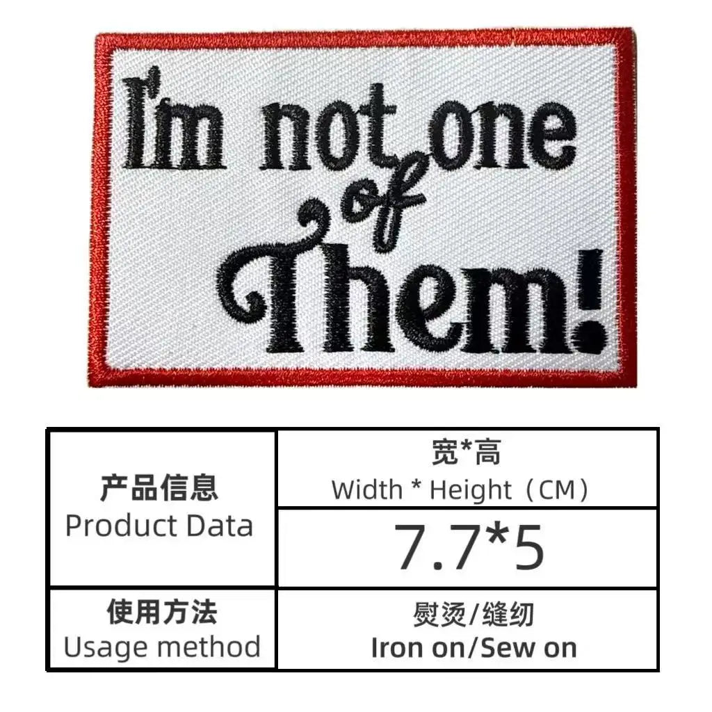 A rectangular embroidered patch with black text on a white background and a red border.