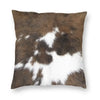 A square cushion cover featuring a brown and white faux fur cowhide print.