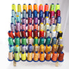 A collection of various colored high tenacity polyester embroidery threads arranged in vertical rows.