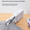 A white portable mini hand sewing machine is shown sewing a striped fabric on a wooden surface.