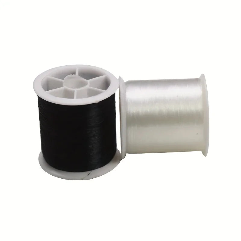 A spool of black invisible nylon sewing thread with a white plastic core and silver metal spindle.