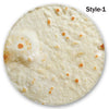 A round, light-colored blanket or throw with scattered orange and brown spots.