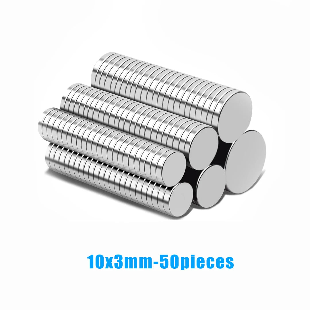 A pile of silver, ribbed magnetic fridge magnets, 50 pieces, measuring 10mm by 3mm.