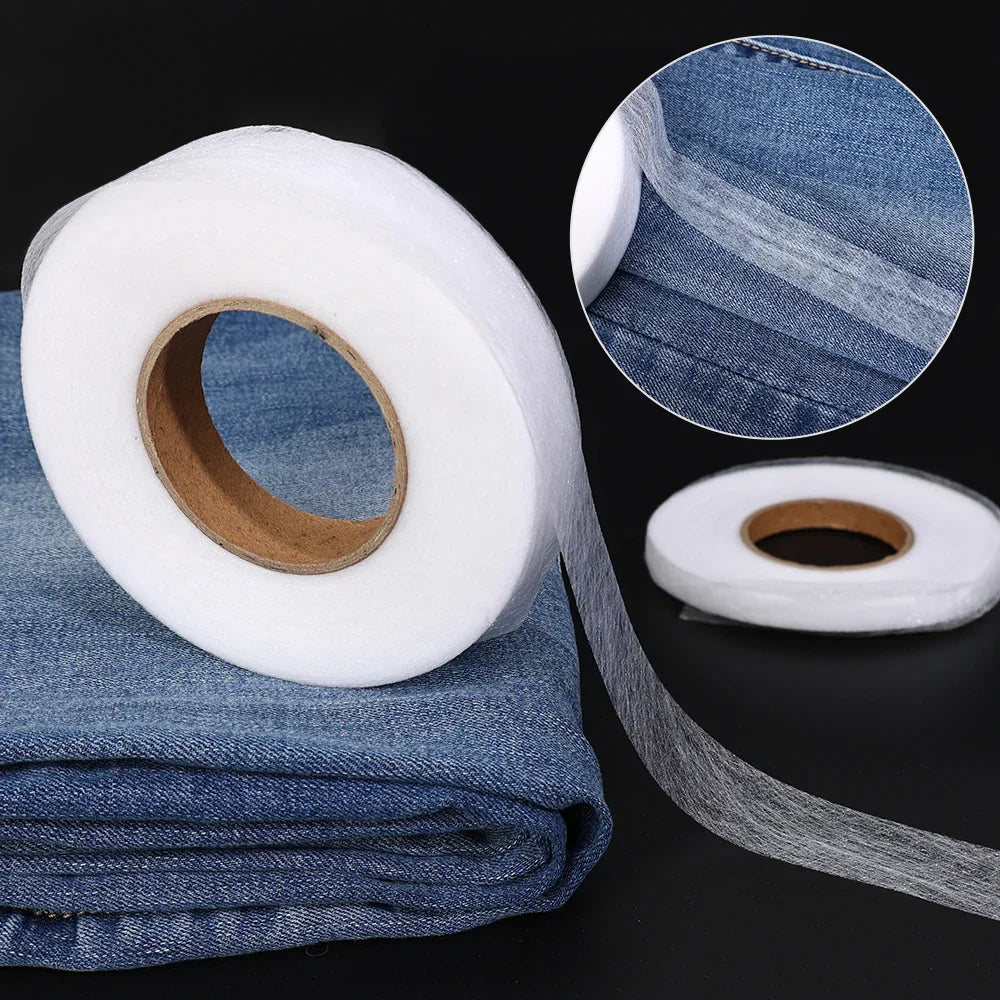 Roll of white double-sided heat-resistant interlining tape with a blue denim fabric swatch and a circular cross-section view