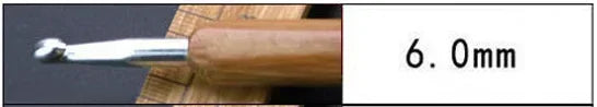 A close-up view of a wooden handle and metal tip for crochet knitting needles, labeled with a 6.0mm size.