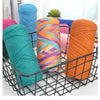 A collection of brightly colored, thick polyester blended yarn skeins in various shades of blue, green, orange, and purple ar