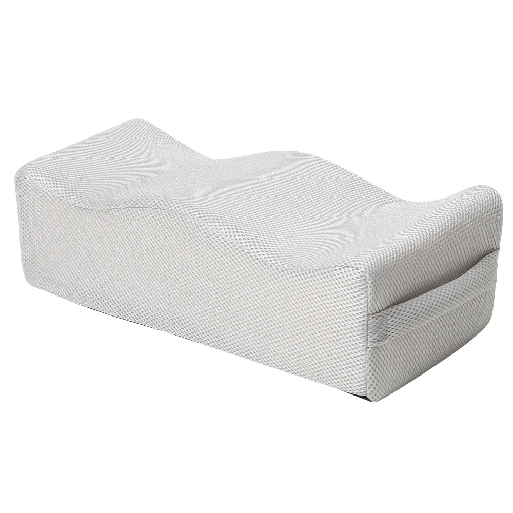 A white ergonomic seat cushion designed for tailbone relief and hip support.