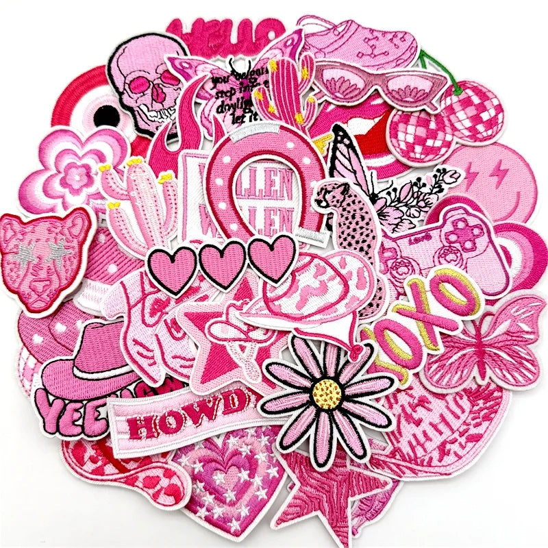 A collection of pink embroidered applique patches featuring skulls, flowers, hearts, and various decorative elements for DIY 
