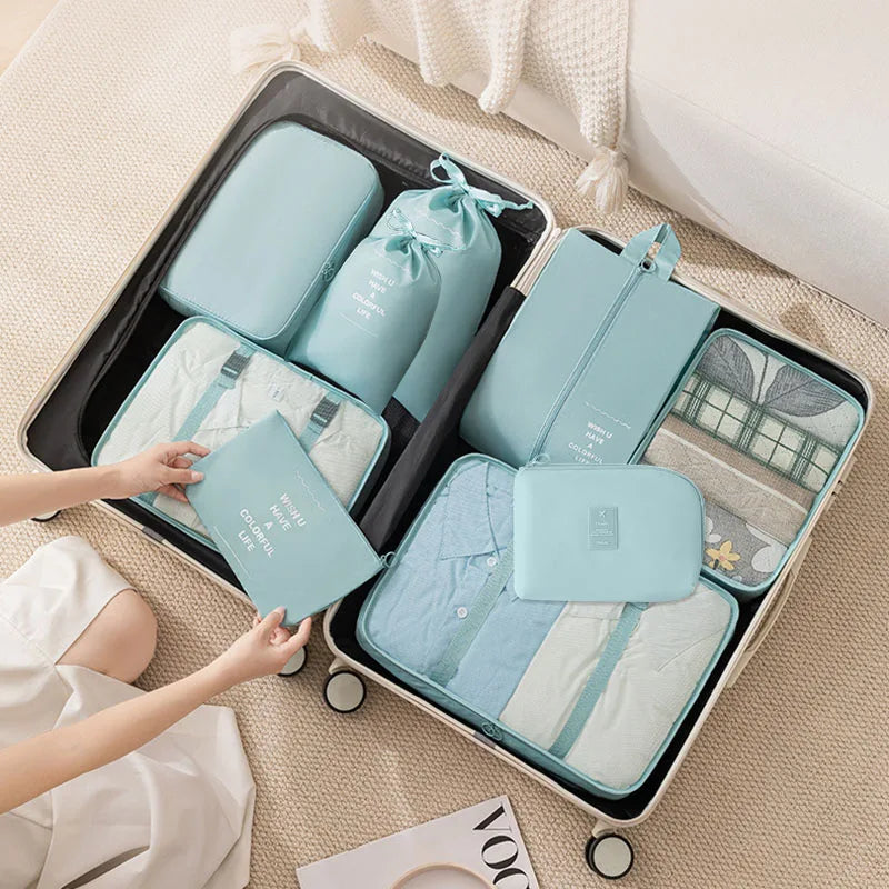 A portable mesh storage organizer set containing various light blue and white fabric pouches and accessories.