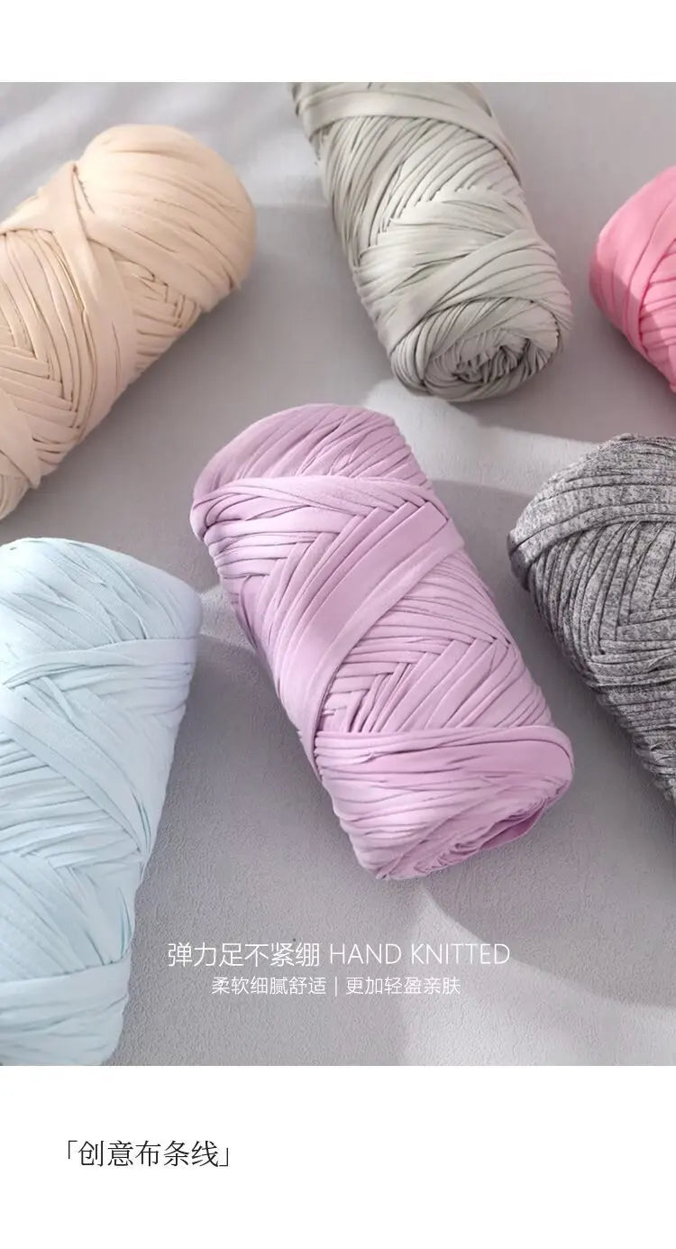 A collection of hand knitted elastic yarn in various shades of pink, gray, and light blue.