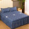Navy blue fitted bed sheets with white star patterns and elastic lace trim on a bed.