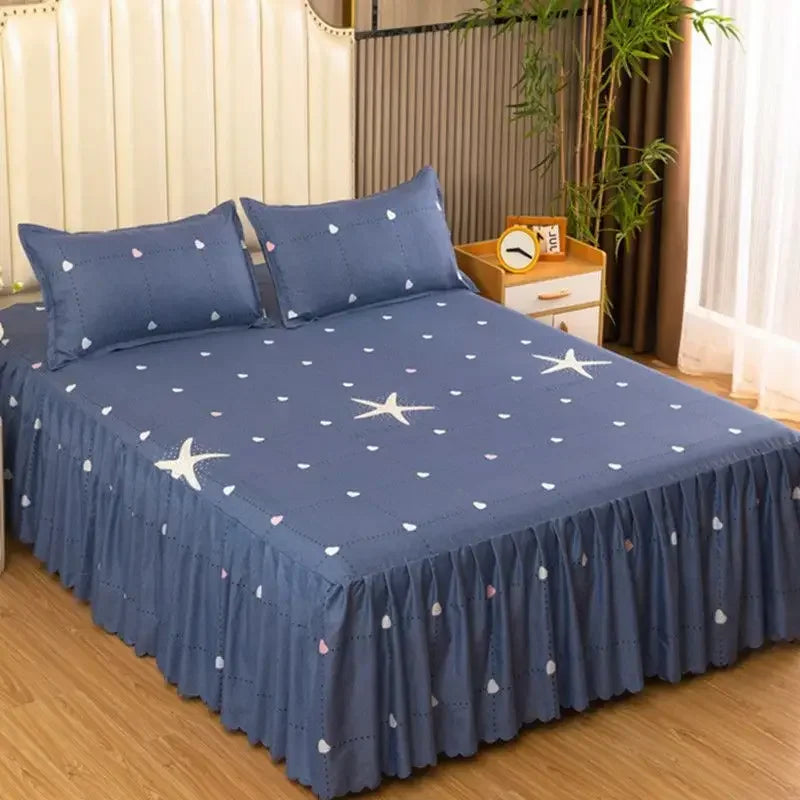 Navy blue fitted bed sheets with white star patterns and elastic lace trim on a bed.