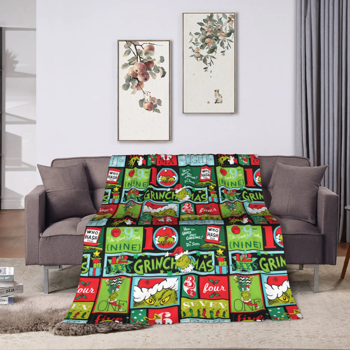 A colorful plaid throw blanket featuring Christmas and holiday themes draped on a sofa.