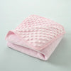 A stack of pink, quilted fleece swaddle blankets for infants and toddlers.