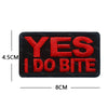 Black embroidered patch with red text saying YES I DO BITE