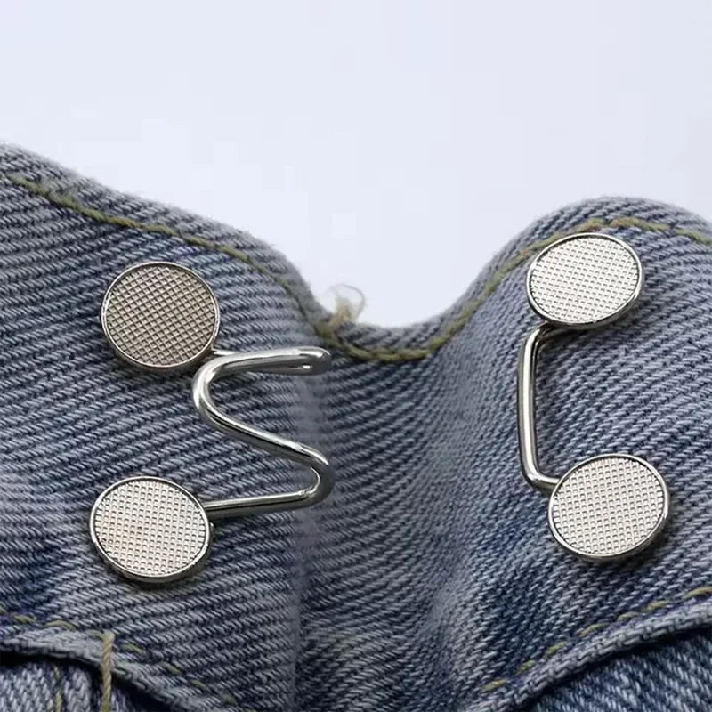 Silver metal button snaps attached to denim fabric