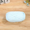 A ball of light blue flat thread yarn lying on a wooden surface.