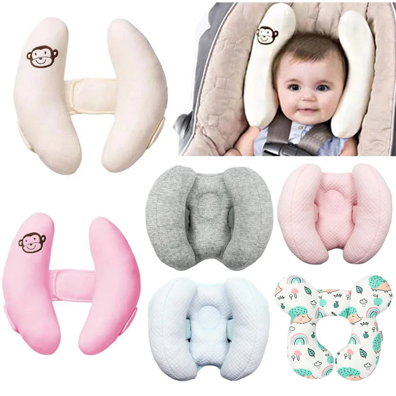 Various pink and gray baby head and neck support pillows for strollers and car seats