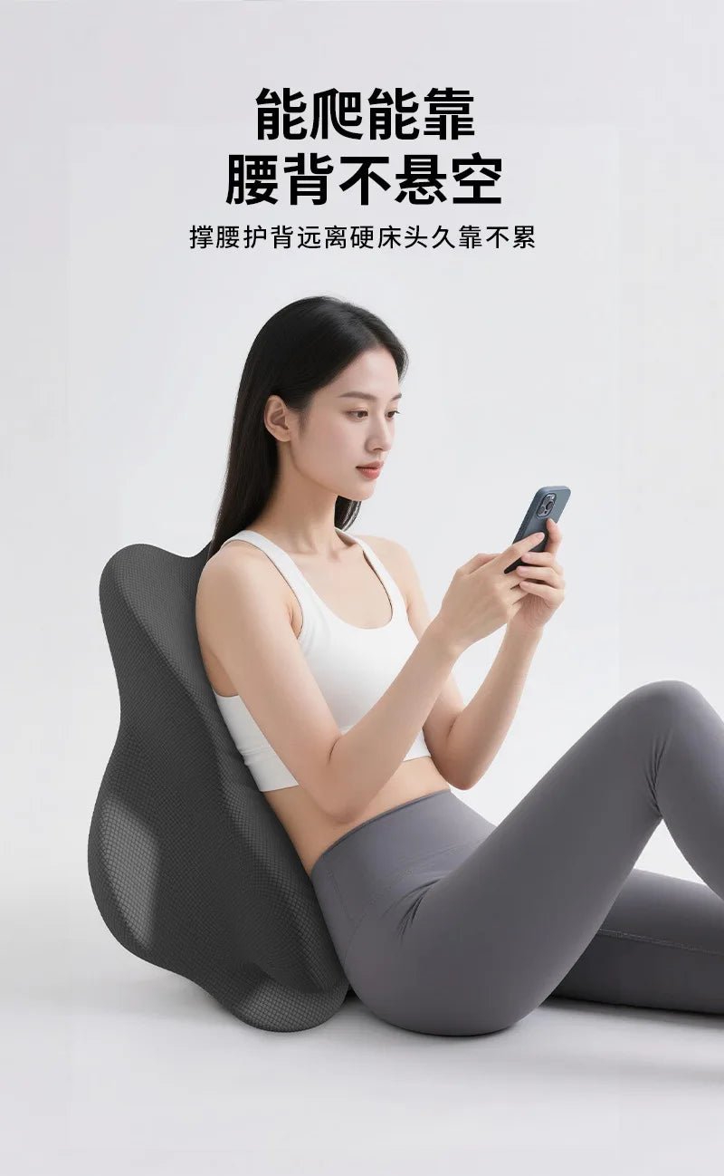 A woman is sitting on an ergonomic memory foam pillow while using a smartphone.